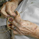 Mary Behrman works on a pine needle basket